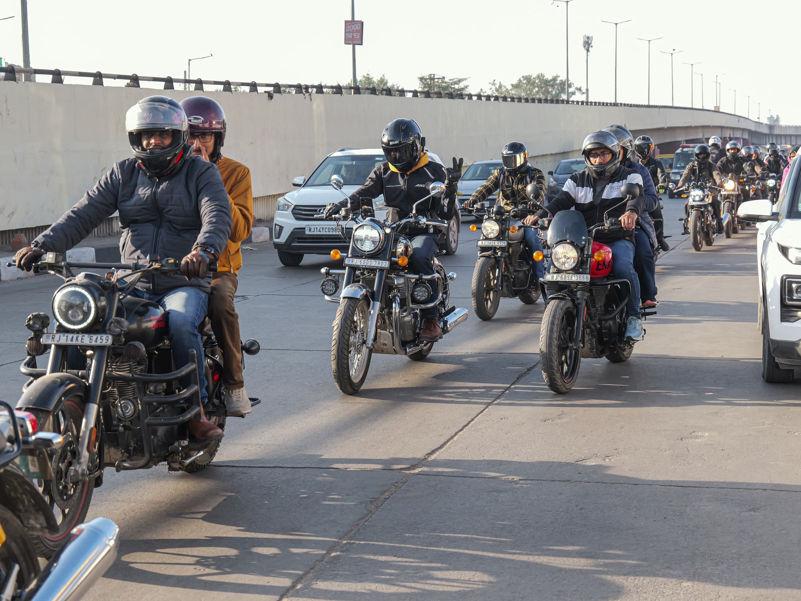 Riders moving off down the road in loose formation