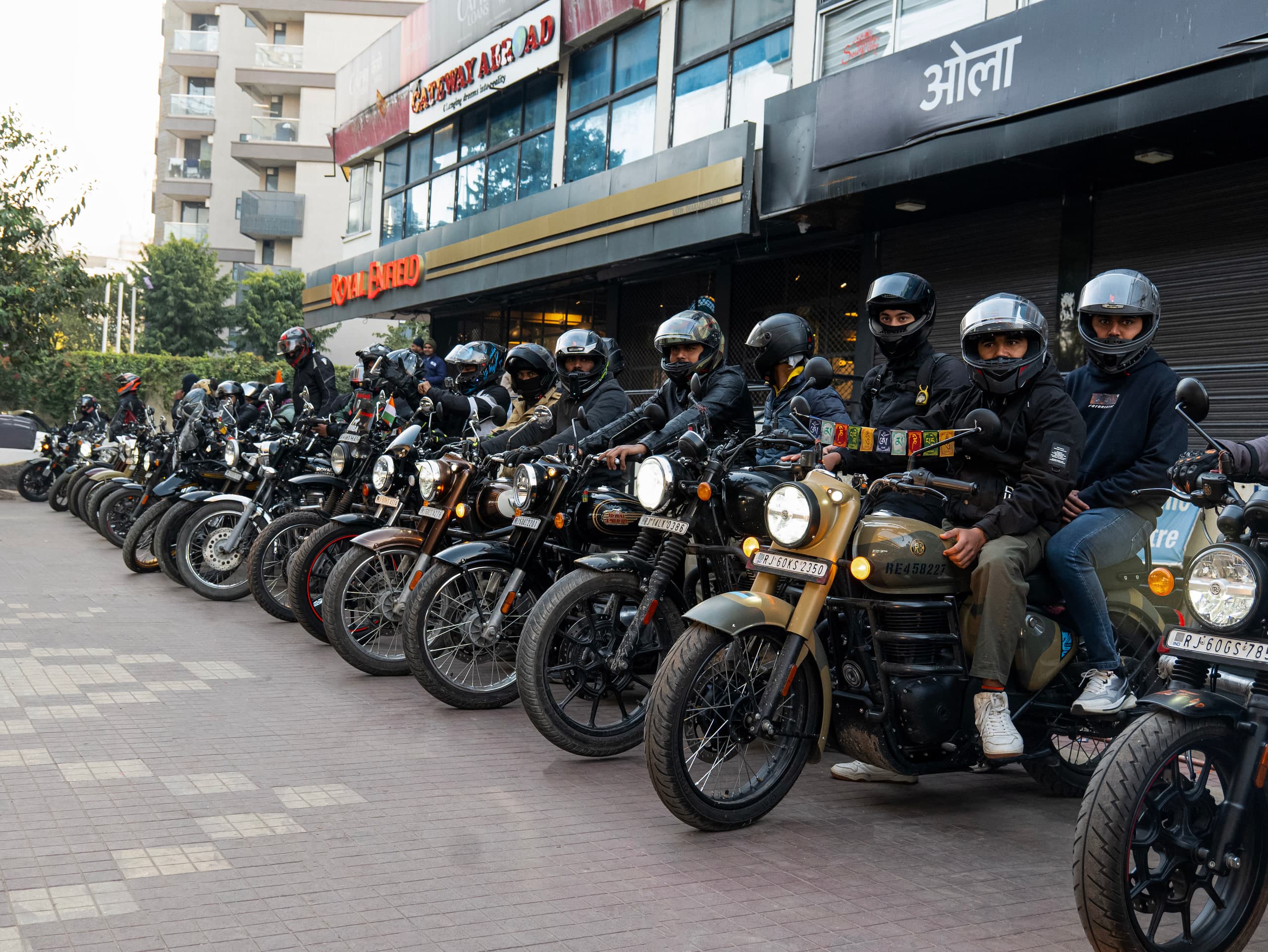 Rows of parked motorcycles with their riders standing alongside