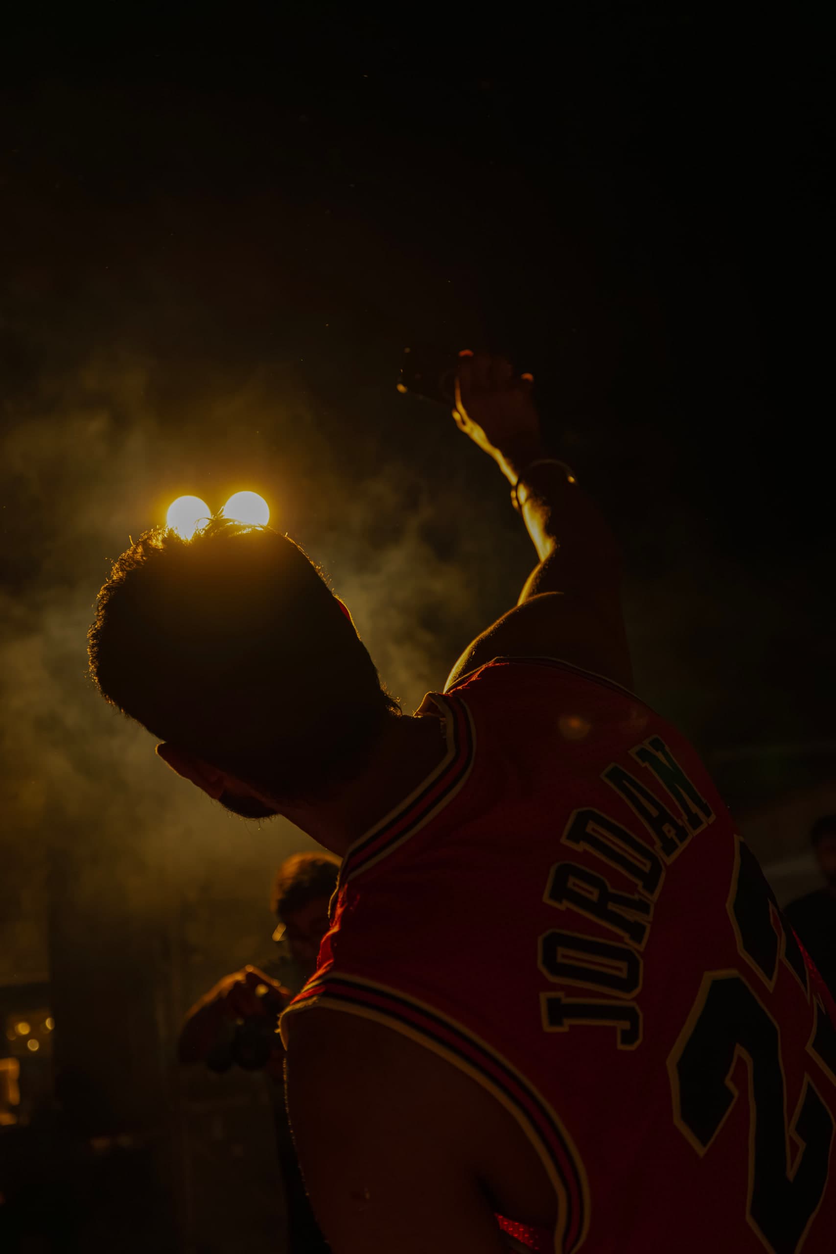 Silhouette in gold smoke, the jersey number just readable through it