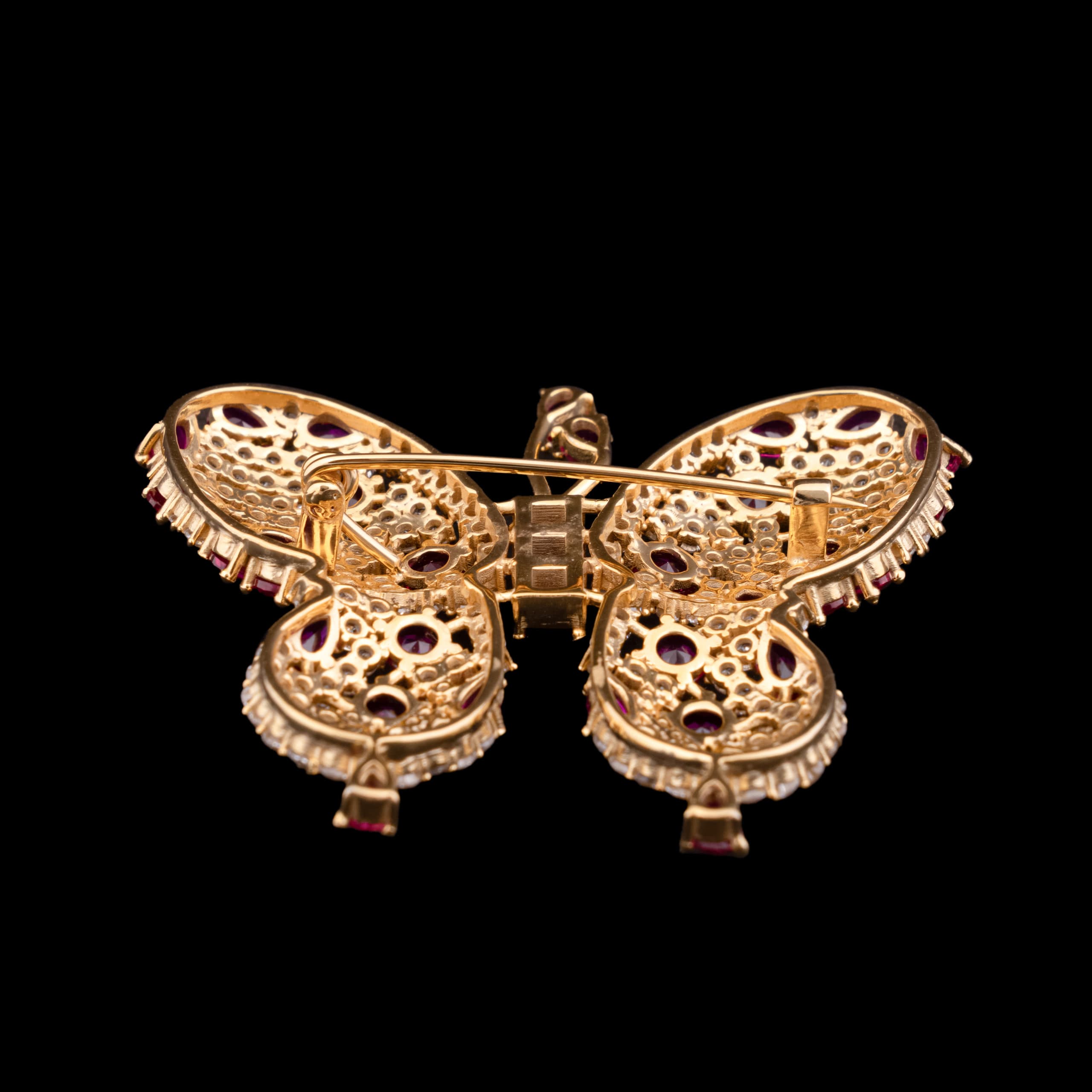 Reverse of the butterfly brooch at a low angle, showing the hinge and catch of the pin