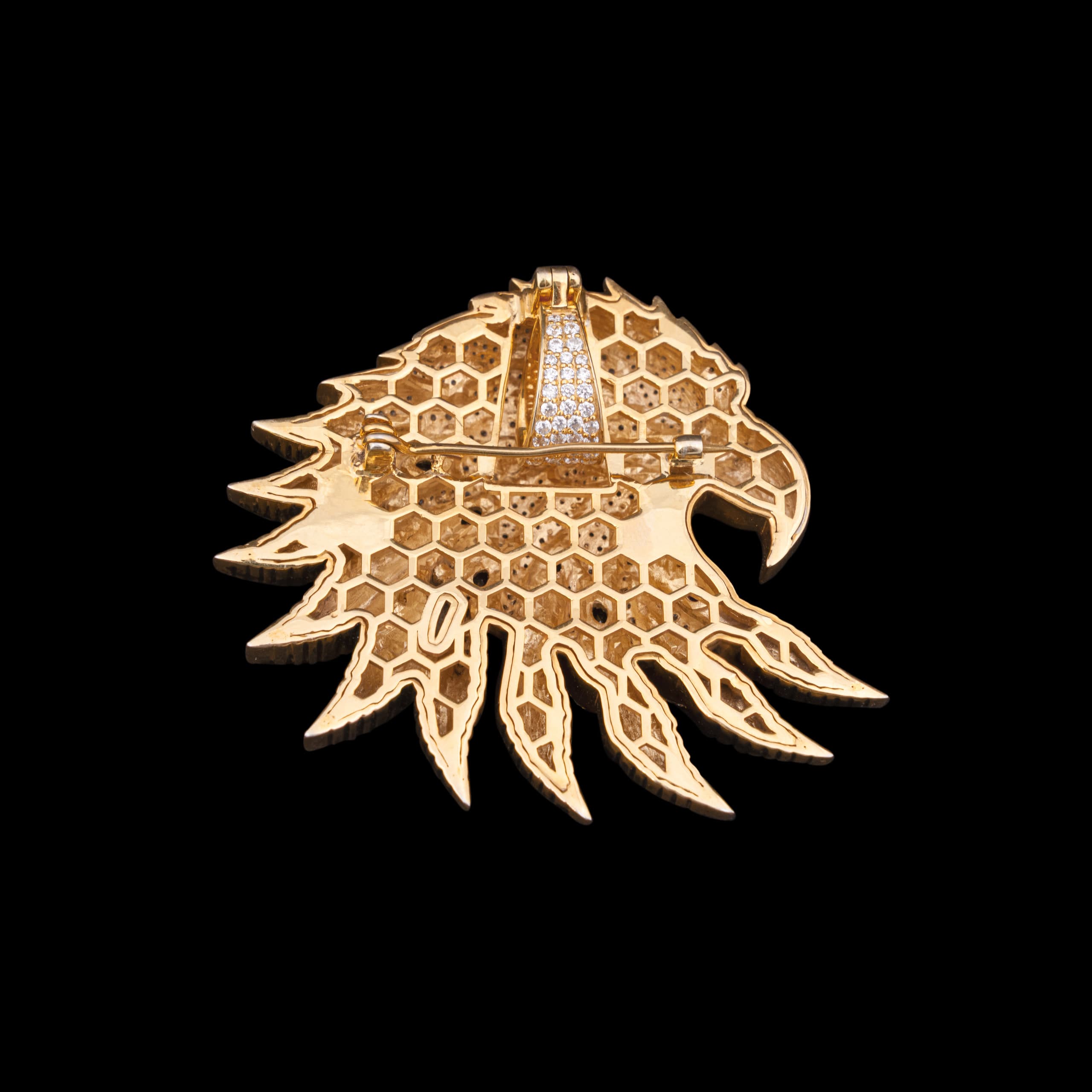 Back of the eagle pendant, gold openwork honeycomb behind every set stone