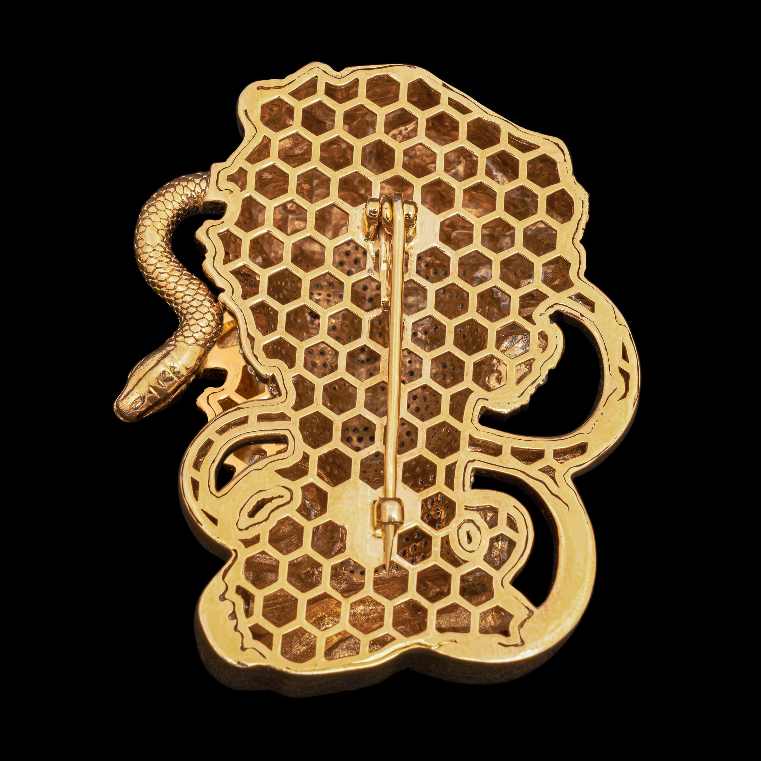 Back of the Medusa brooch, one snake's tail curling clear of the honeycombed gold plate