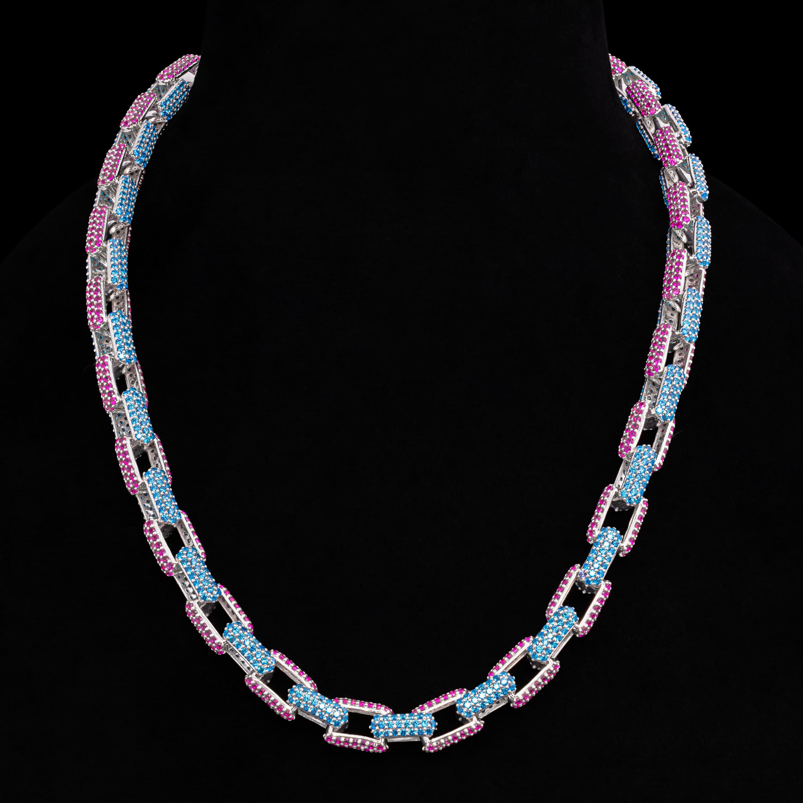Choker of pink and blue pavé links displayed on a black bust