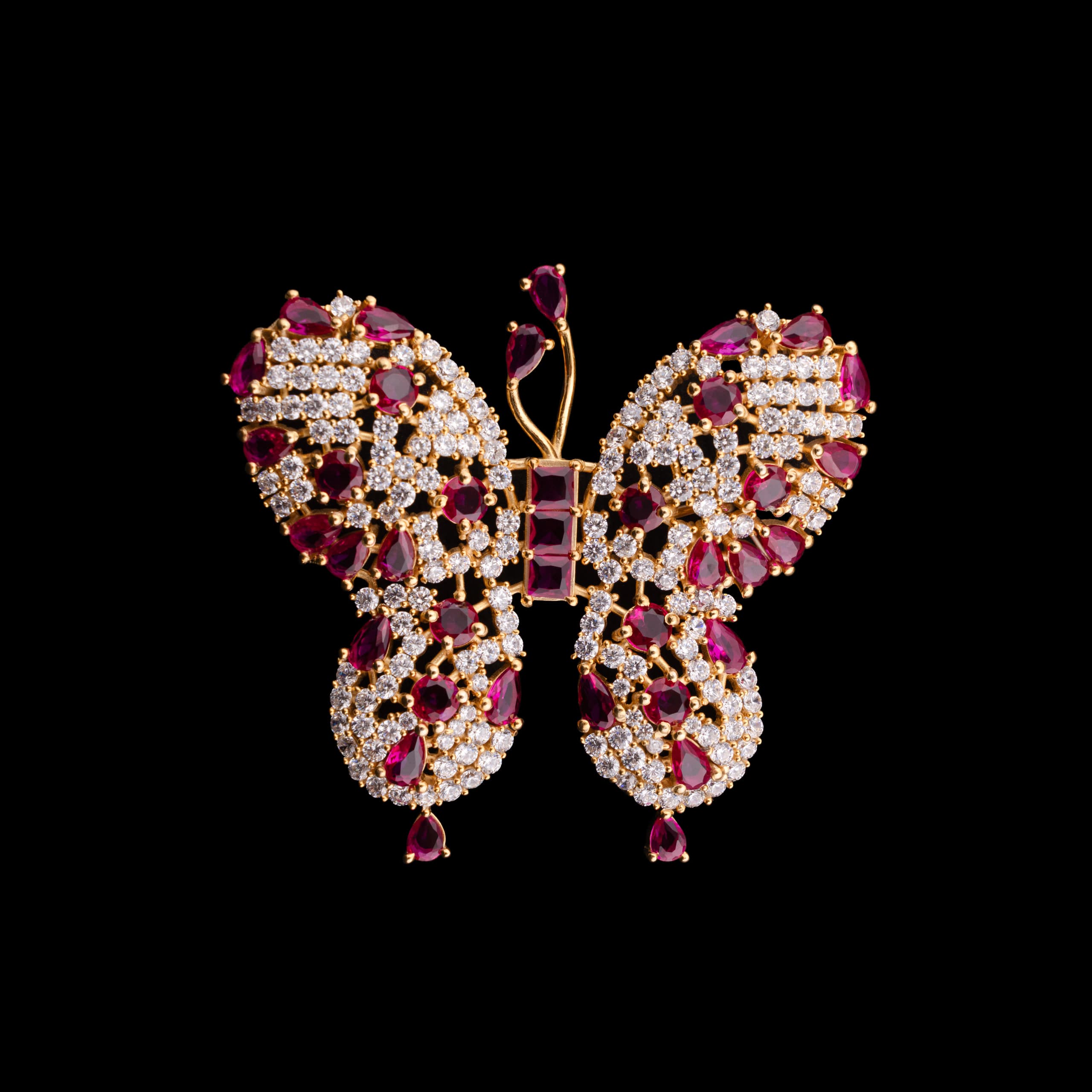 Butterfly brooch set with rubies and pavé stones, wings spread