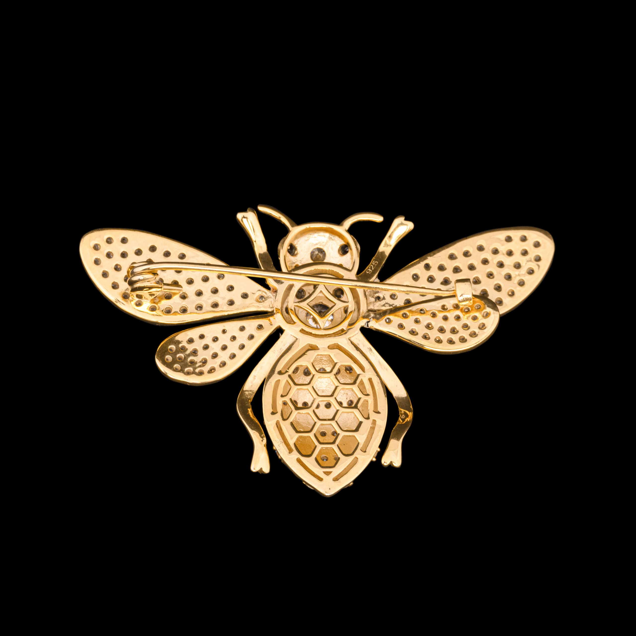 Gold bee pendant, honeycomb pattern across its body and wings