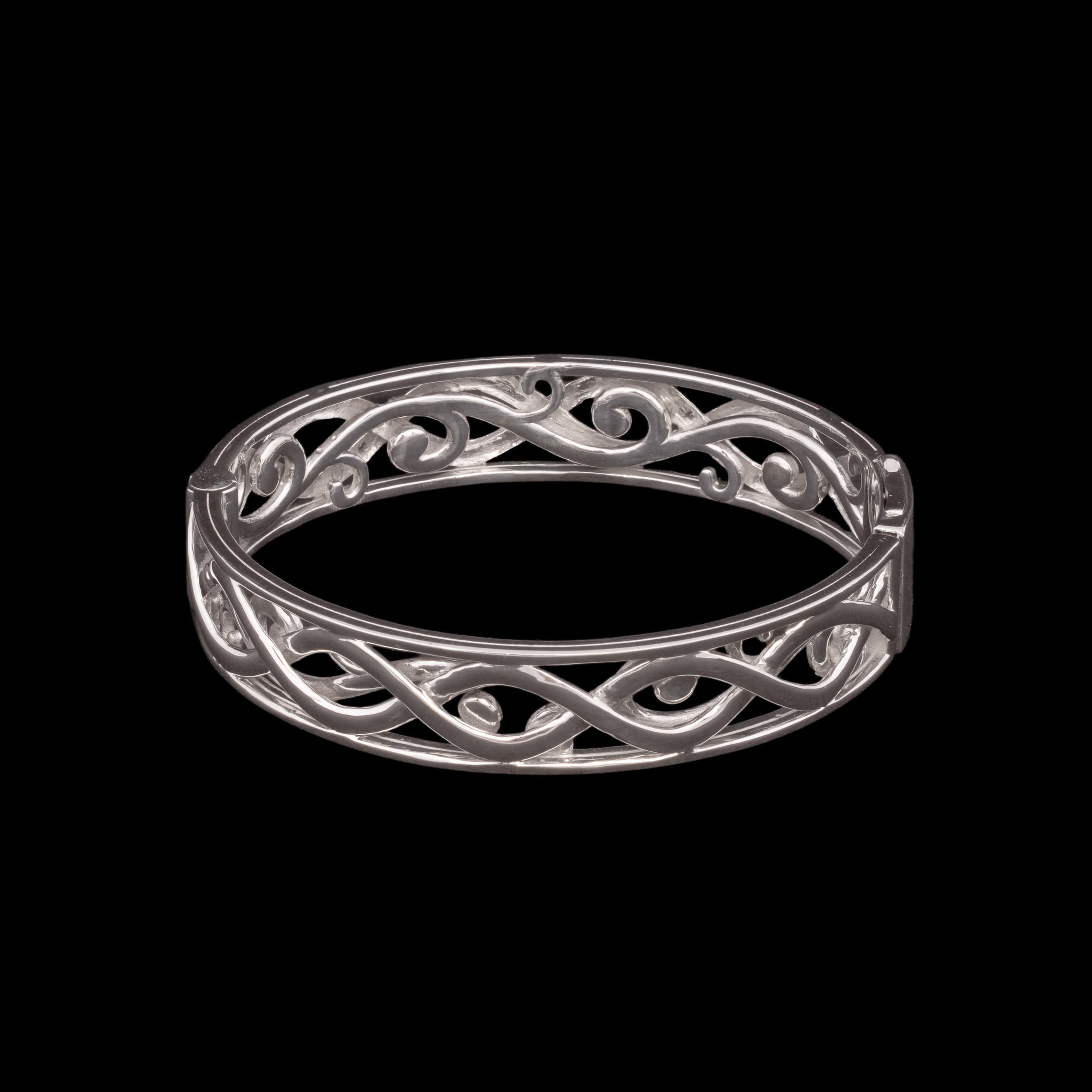 Silver bangle pierced with a running filigree vine