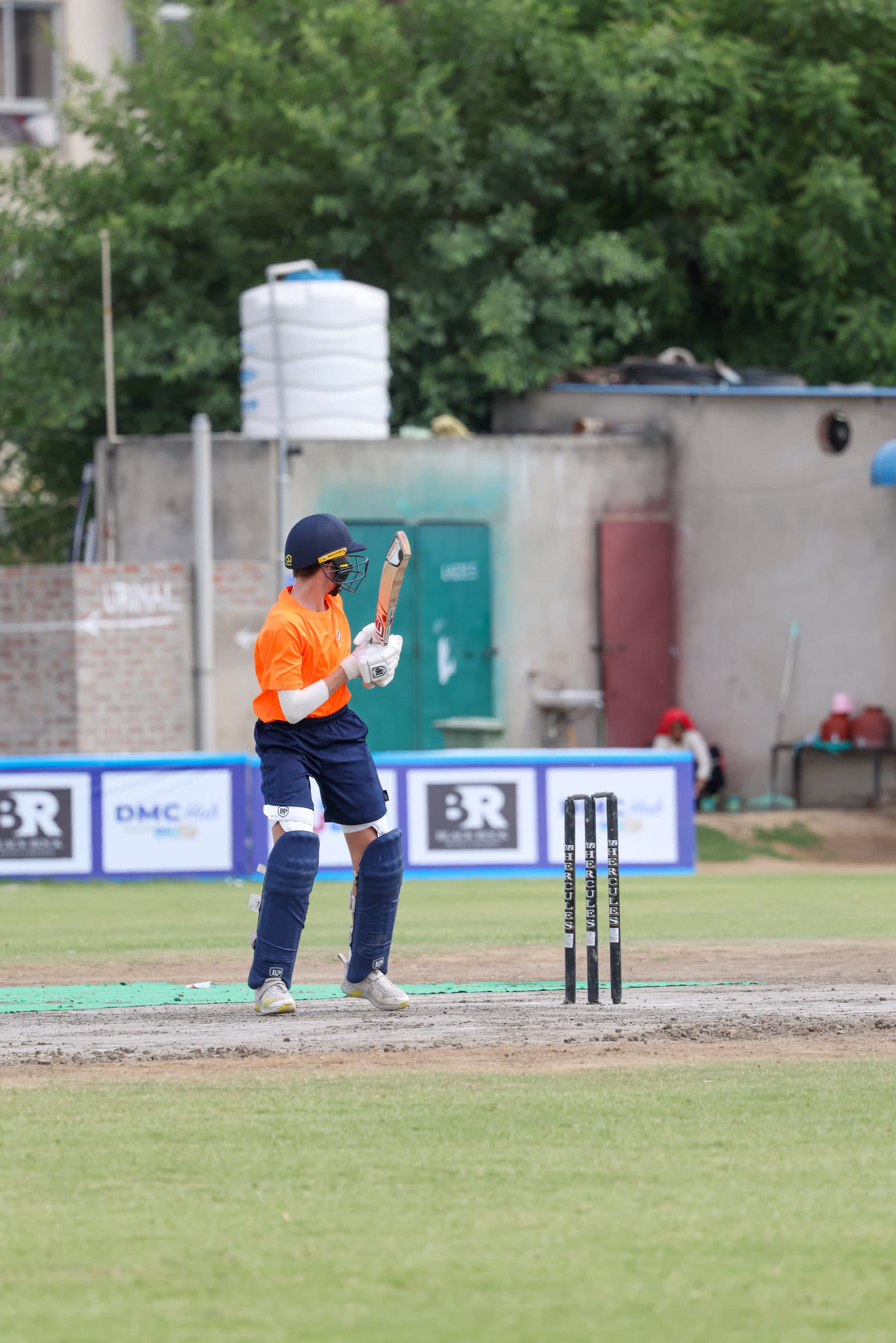 Batter pushing forward defensively, ball down on the pitch, keeper up at the stumps
